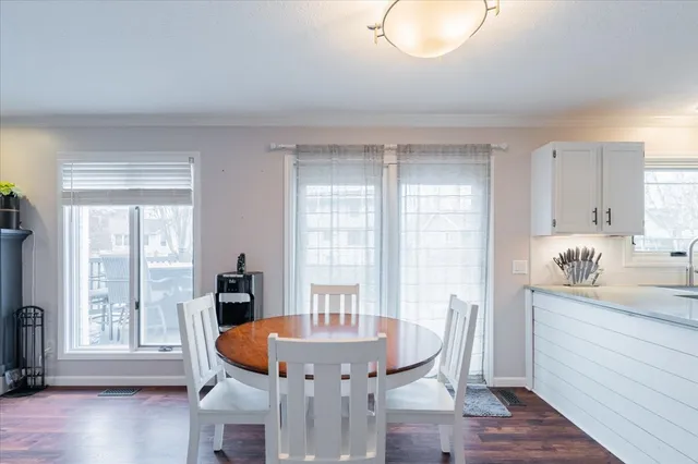 a dining room with furniture and wooden floor