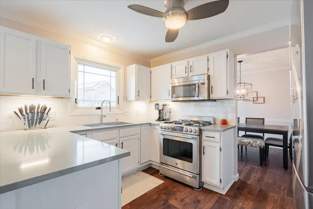 a kitchen with stainless steel appliances granite countertop a stove a sink and a refrigerator