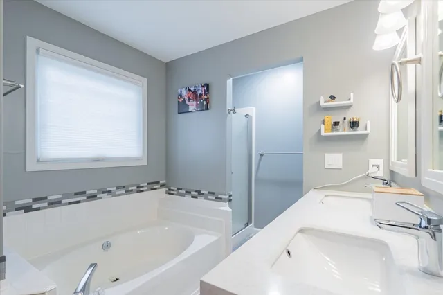 a bathroom with a tub and a sink