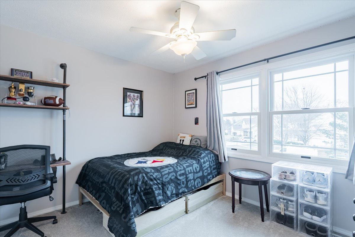 607 Old Farm Road Bloomington, IL 61704 - Photo 24 of 40 a bedroom with a bed and a dresser next to a window