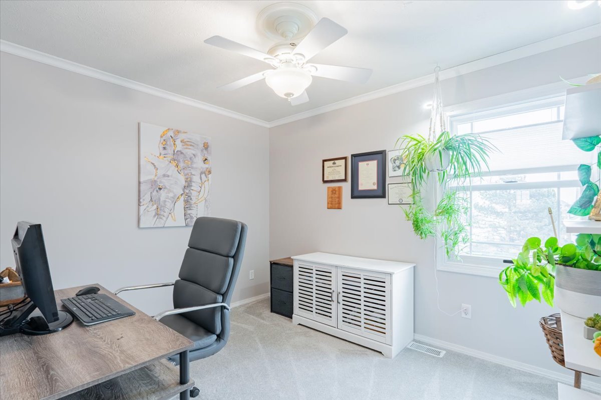 607 Old Farm Road Bloomington, IL 61704 - Photo 27 of 40 a view of a workspace with furniture and a window