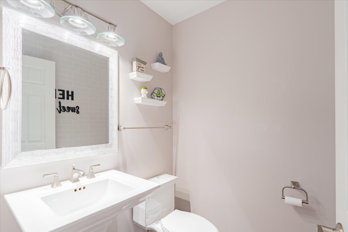 607 Old Farm Road Bloomington, IL 61704 - Photo 9 of 40 a bathroom with a sink a toilet and mirror
