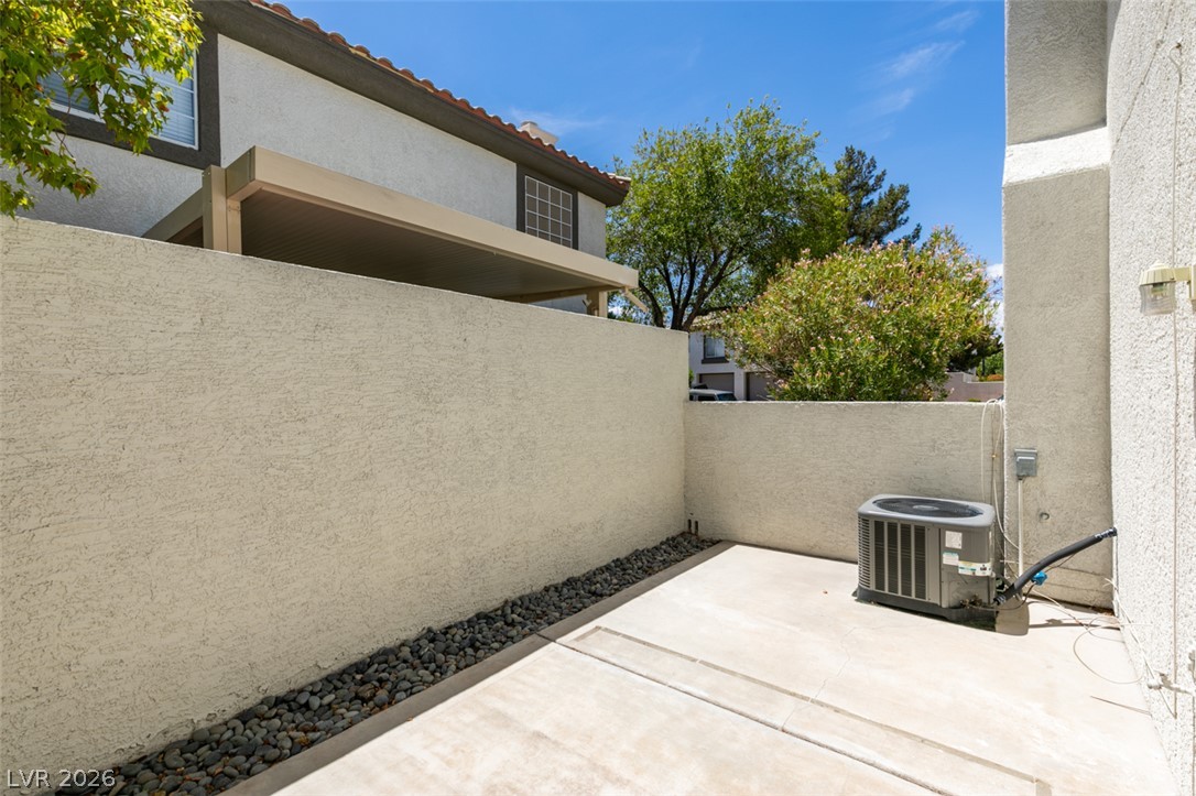 200 Luninborg Street Henderson, NV 89074 - Photo 5 of 40 A compact patio space offers low-maintenance outdoor enjoyment with textured walls and gravel accents.