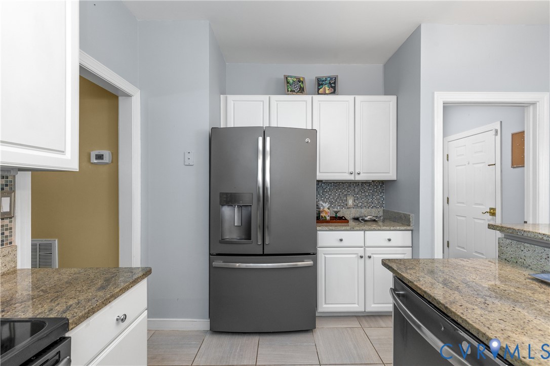 2205 Magnolia Grove Way Midlothian, VA 23113 - Photo 14 of 37 a kitchen with a stove a sink and a refrigerator