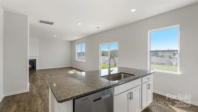 a kitchen with granite countertop a sink and a window
