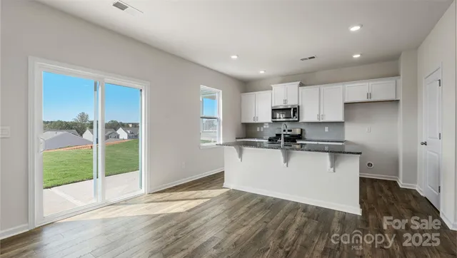 a kitchen with sink a refrigerator and wooden cabinets