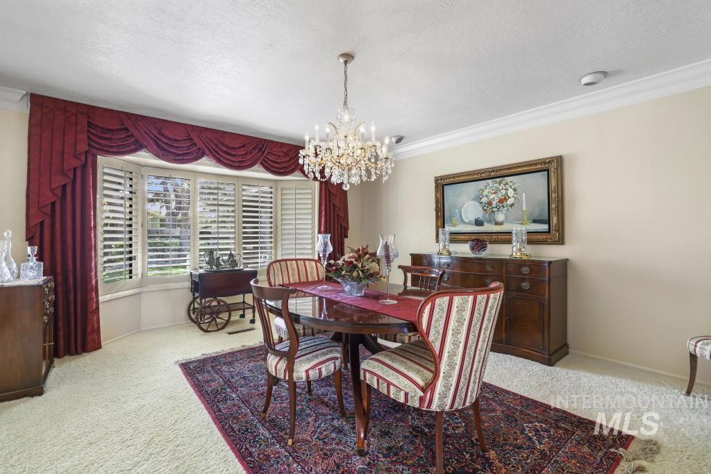 2018 Rancho Vista Drive Twin Falls, ID 83301 - Photo 10 of 50 Formal dining area featuring a bay window with plantation shutters and red valance