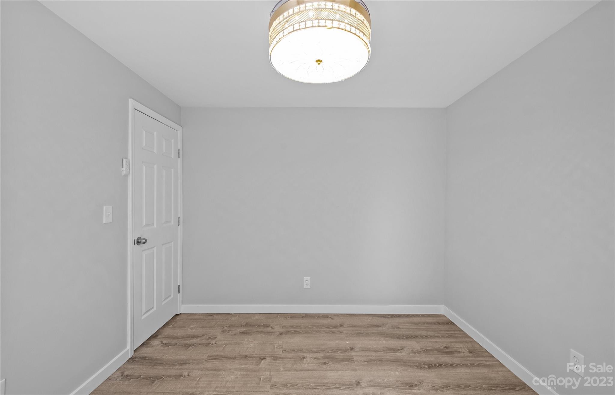 5100 Grand Canyon Road Northwest Concord, NC 28027 - Photo 11 of 39 a view of a room with wooden floor and white wall