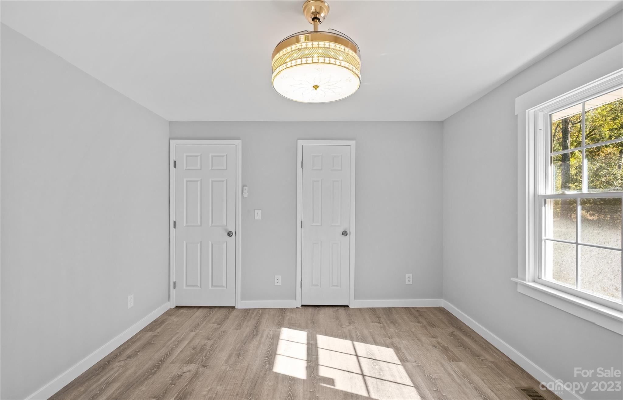 5100 Grand Canyon Road Northwest Concord, NC 28027 - Photo 14 of 39 an empty room with wooden floor and windows