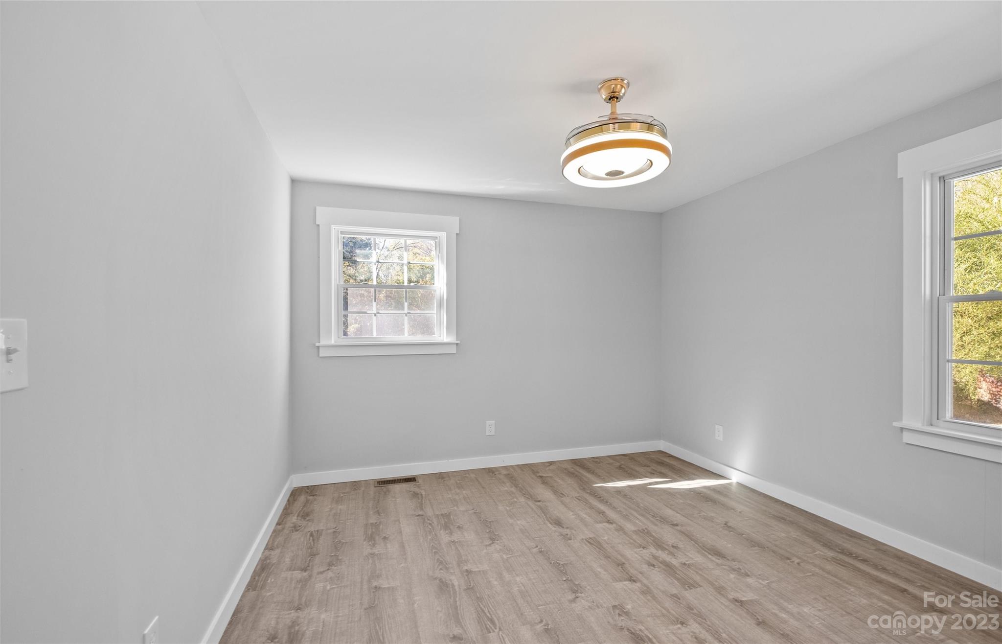 5100 Grand Canyon Road Northwest Concord, NC 28027 - Photo 15 of 39 an empty room with a window and wooden floor