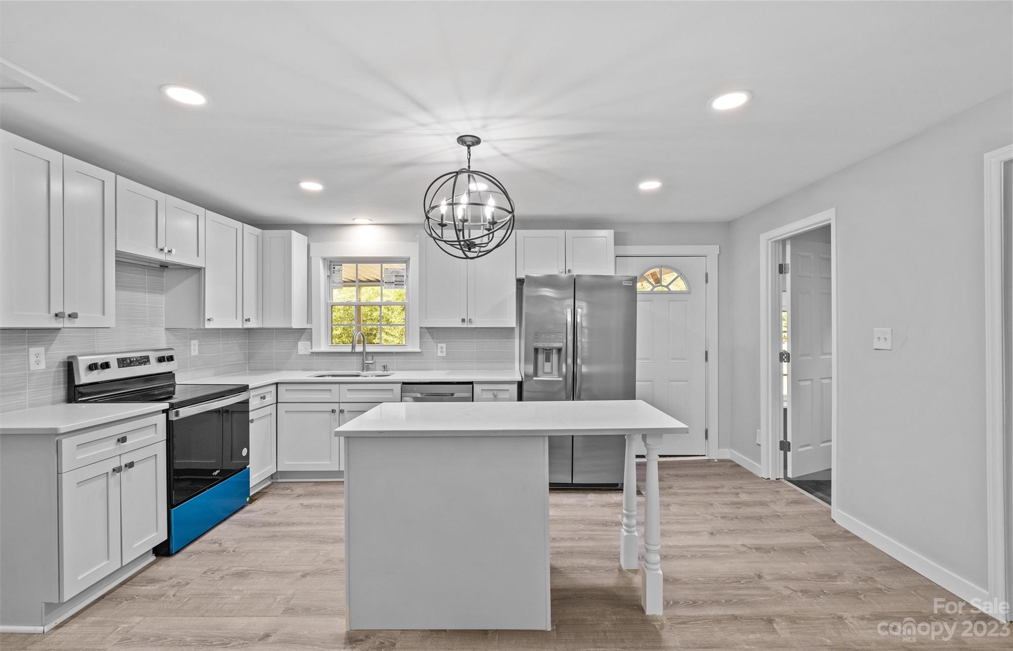 5100 Grand Canyon Road Northwest Concord, NC 28027 - Photo 2 of 39 a large kitchen with stainless steel appliances granite countertop a stove top oven a sink dishwasher and white cabinets next to a window