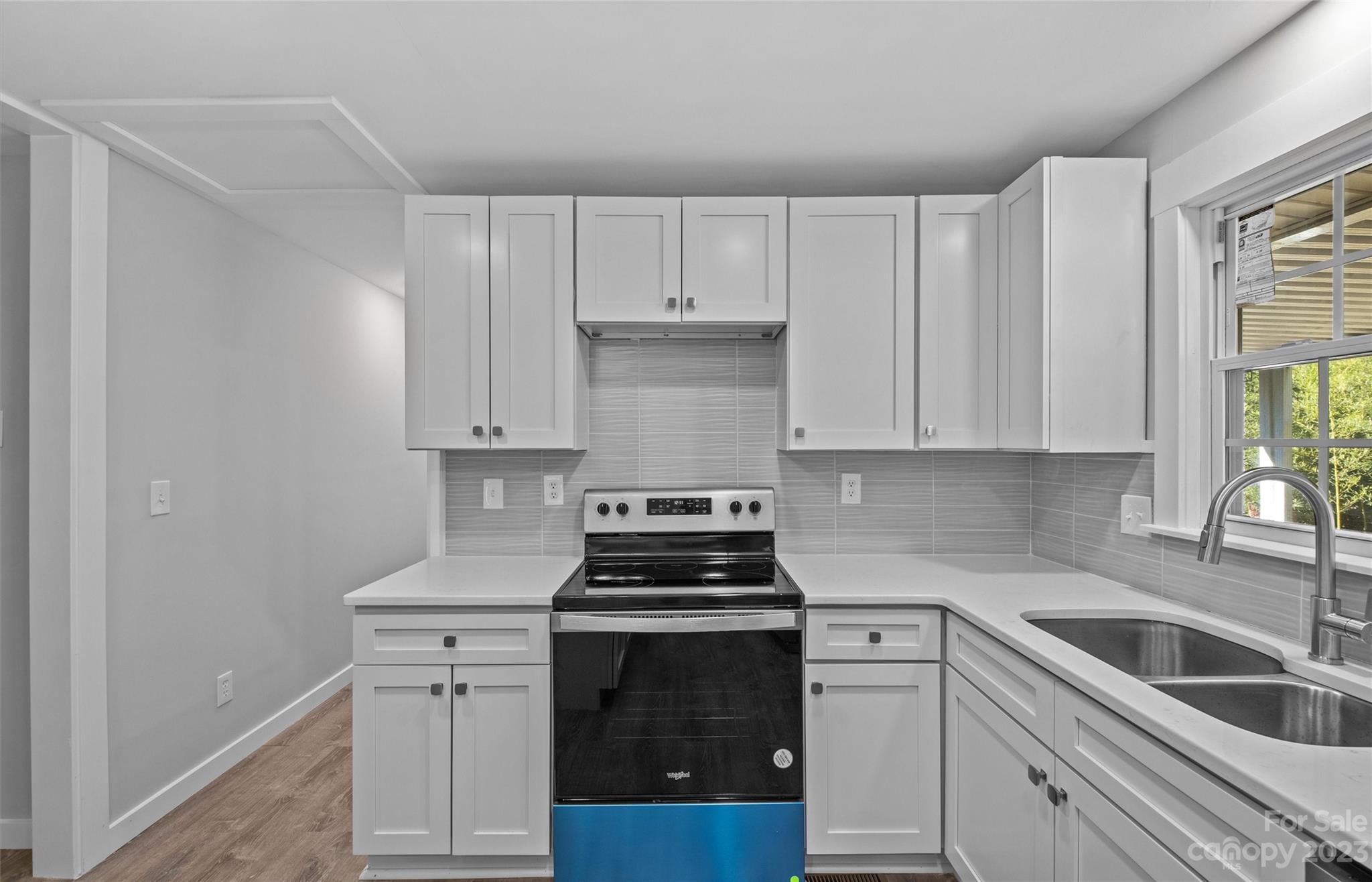 5100 Grand Canyon Road Northwest Concord, NC 28027 - Photo 7 of 39 a kitchen with white cabinets and appliances