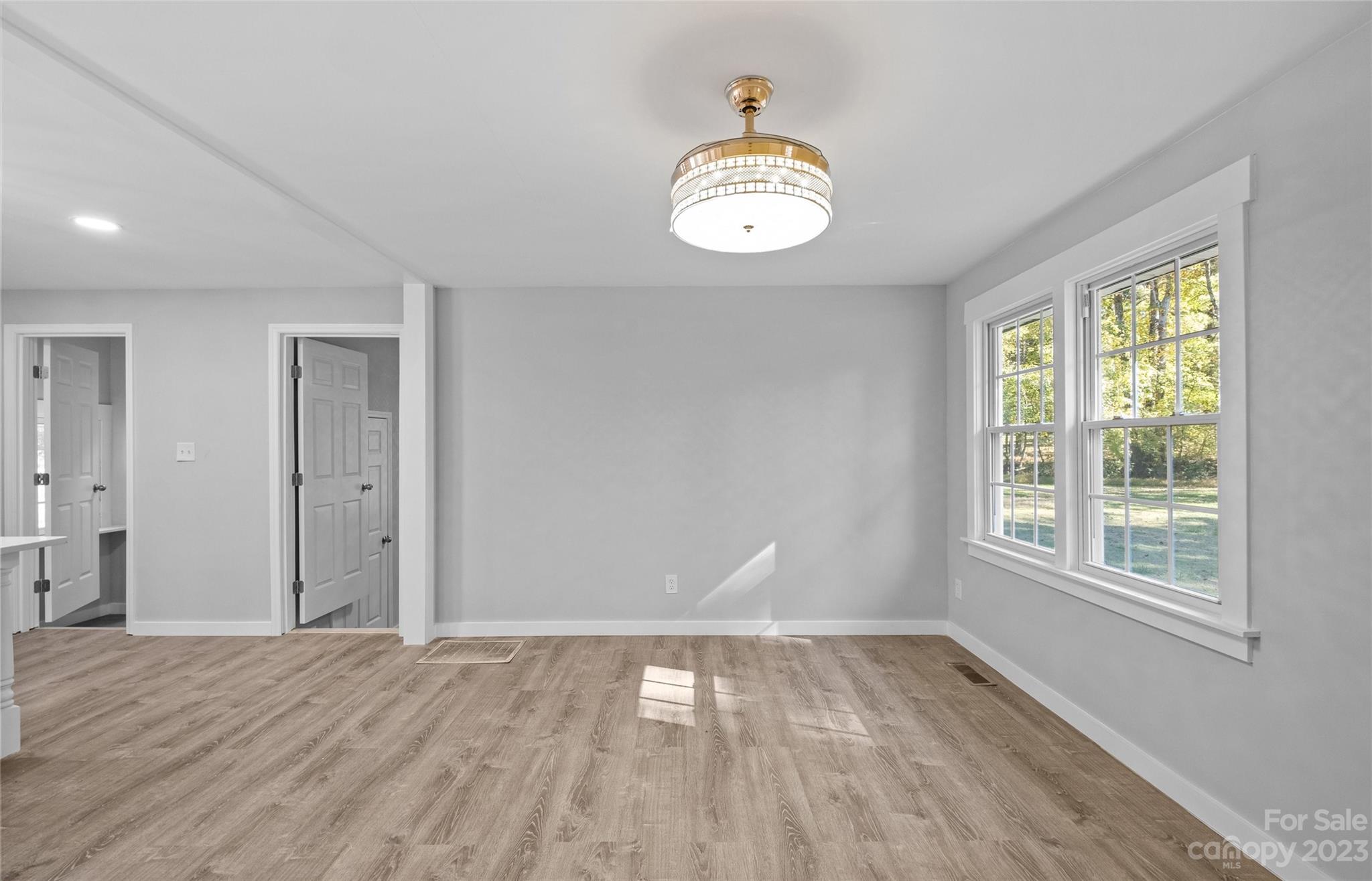 5100 Grand Canyon Road Northwest Concord, NC 28027 - Photo 8 of 39 an empty room with wooden floor and windows