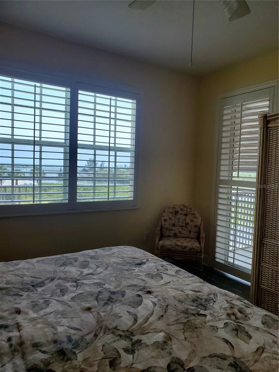 13413 Gasparilla Road, Unit 304 Placida, FL 33946 - Photo 14 of 28 a bedroom with a bed and a window