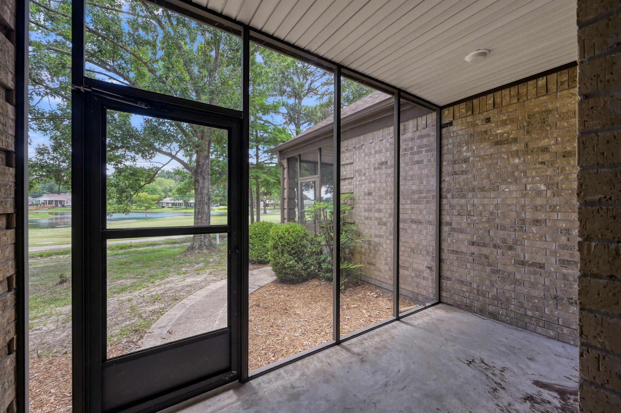 273 Augusta Drive Trinity, TX 75862 - Photo 11 of 21 Smaller of two screened in patios overlooking lake and golf course. (connected to 3rd bedroom/gameroom)