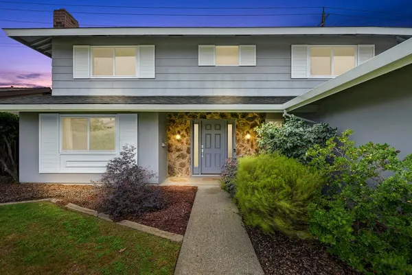 a front view of a house with garden
