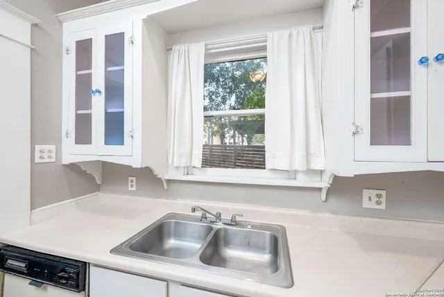 a kitchen with a sink and cabinets