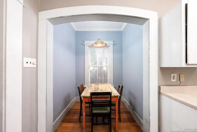 a hallway with front door wooden floor and windows