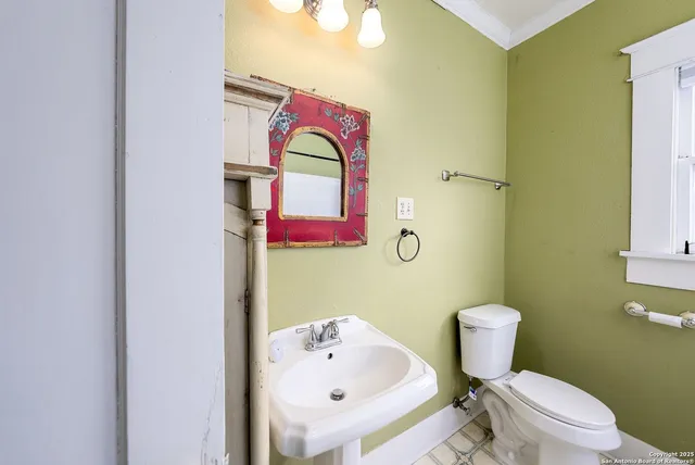 a bathroom with a sink mirror vanity and toilet