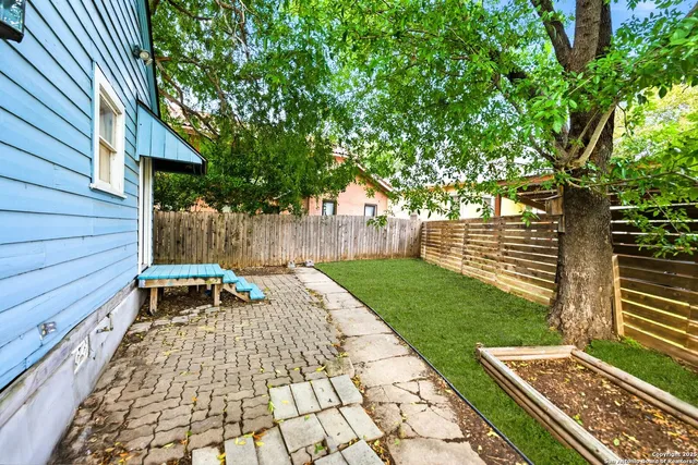 a view of a wooden bench with wooden fence