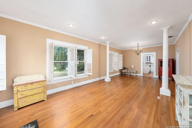 a big room with wooden floor and windows