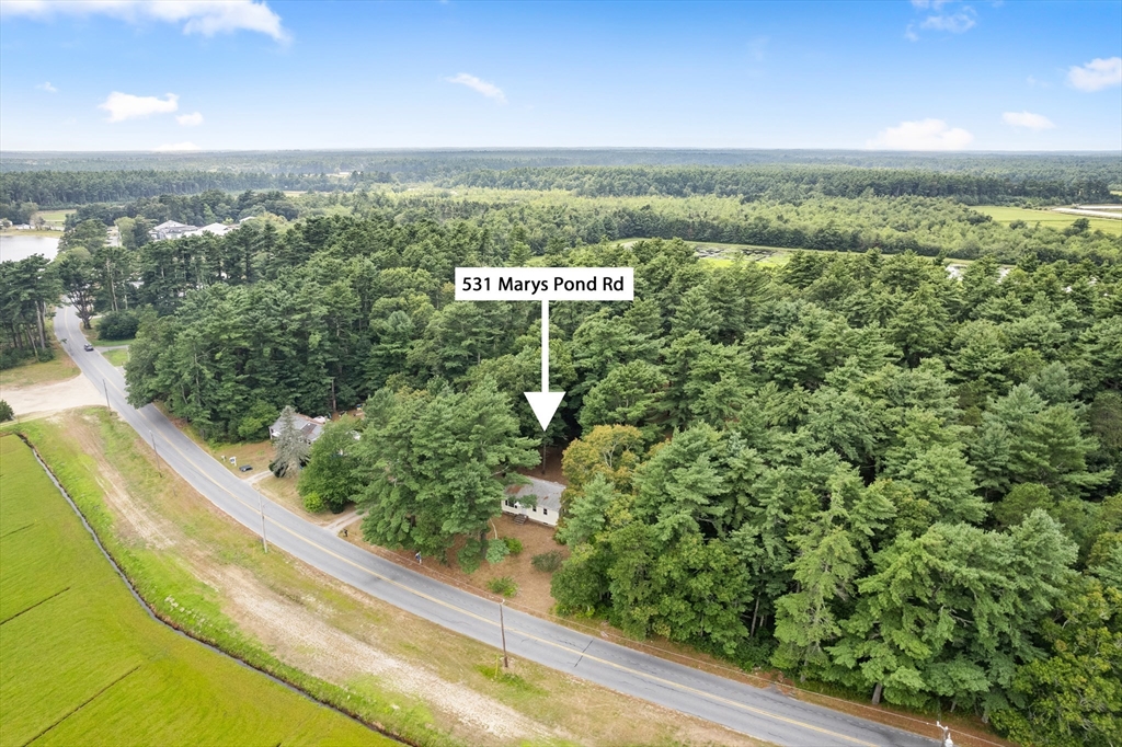 531 Marys Pond Road Rochester, MA 02770 - Photo 1 of 38 a view of a green field with an ocean view