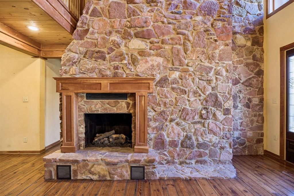 1922 A Bethel-Cannon Road Whitewright, TX 75491 - Photo 7 of 40 Floor-to-ceiling natural stone fireplace with a wood mantel