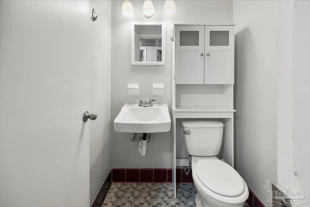 a white toilet sitting next to a bathroom sink