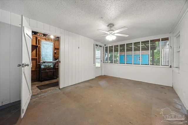 an empty room with windows and closet