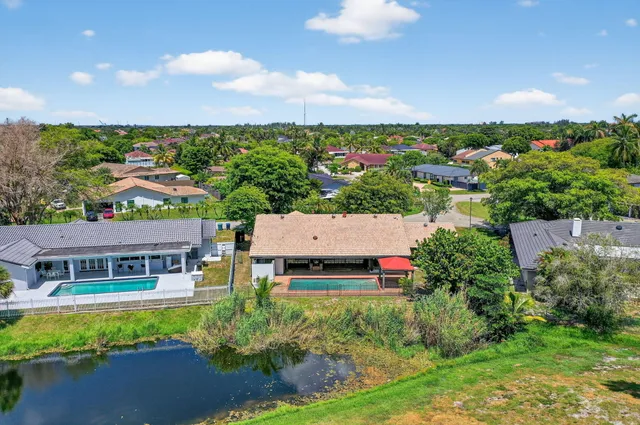 an aerial view of a house with garden space and street view