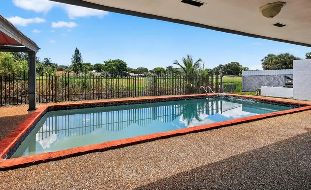 a view of swimming pool with seating space and outdoor view