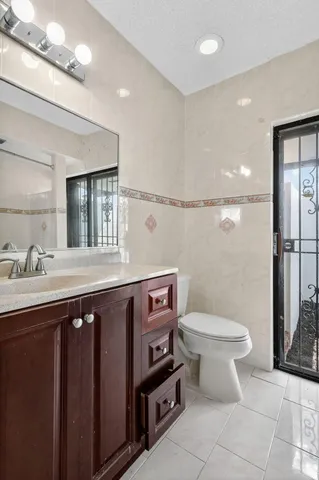 a bathroom with a sink a toilet and a mirror