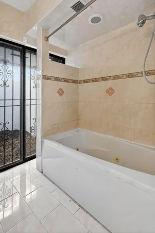 a bathroom with a bathtub and shower