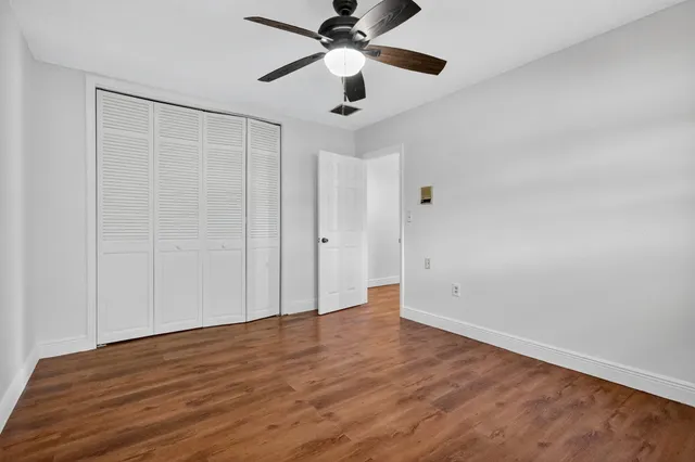 a view of an empty room with a ceiling fan