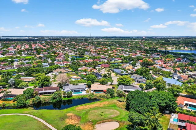 an aerial view of a city with lots of buildings and mountain view in back
