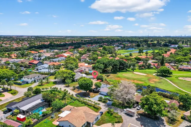 an aerial view of a houses with a swimming pool