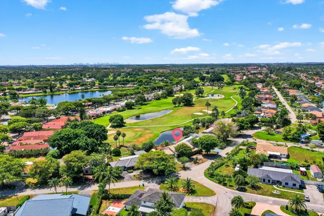 an aerial view of a houses with a yard