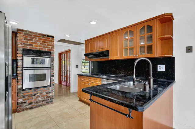 a kitchen with stainless steel appliances granite countertop a stove and a sink