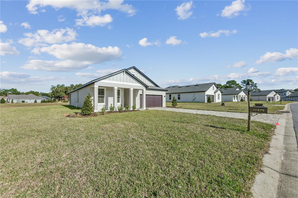 17875 Southwest 68th Place Dunnellon, FL 34432 - Photo 2 of 14 a front view of a house with garden