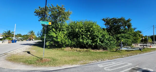a backyard of a house with a yard and outdoor seating