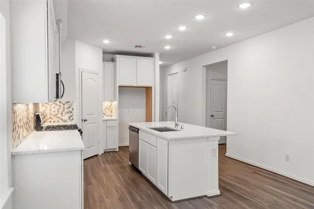 a room with a sink a washer and dryer