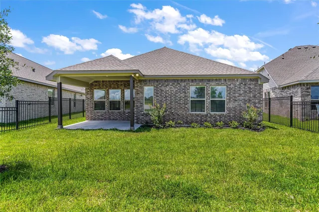 a brick building with a yard in front of it