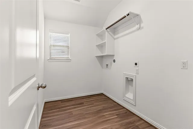 a view of a room with wooden floor and white walls
