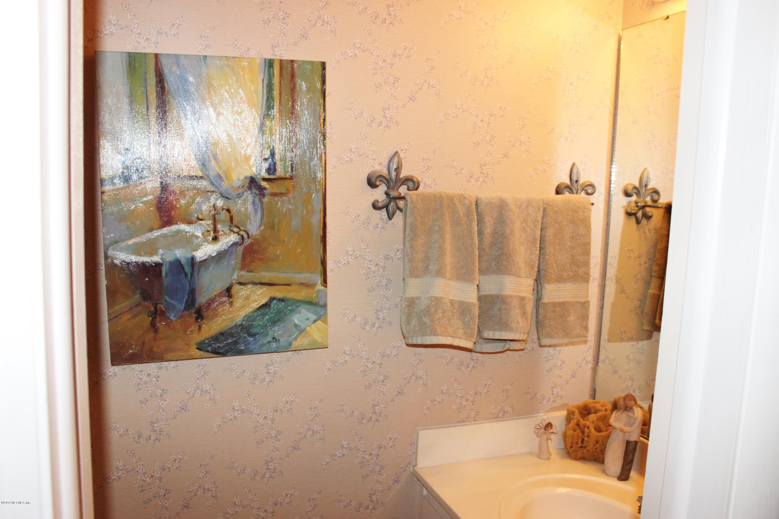 5512 Stanford Road Jacksonville, FL 32207 - Photo 12 of 22 a bathroom with a granite countertop sink and a mirror