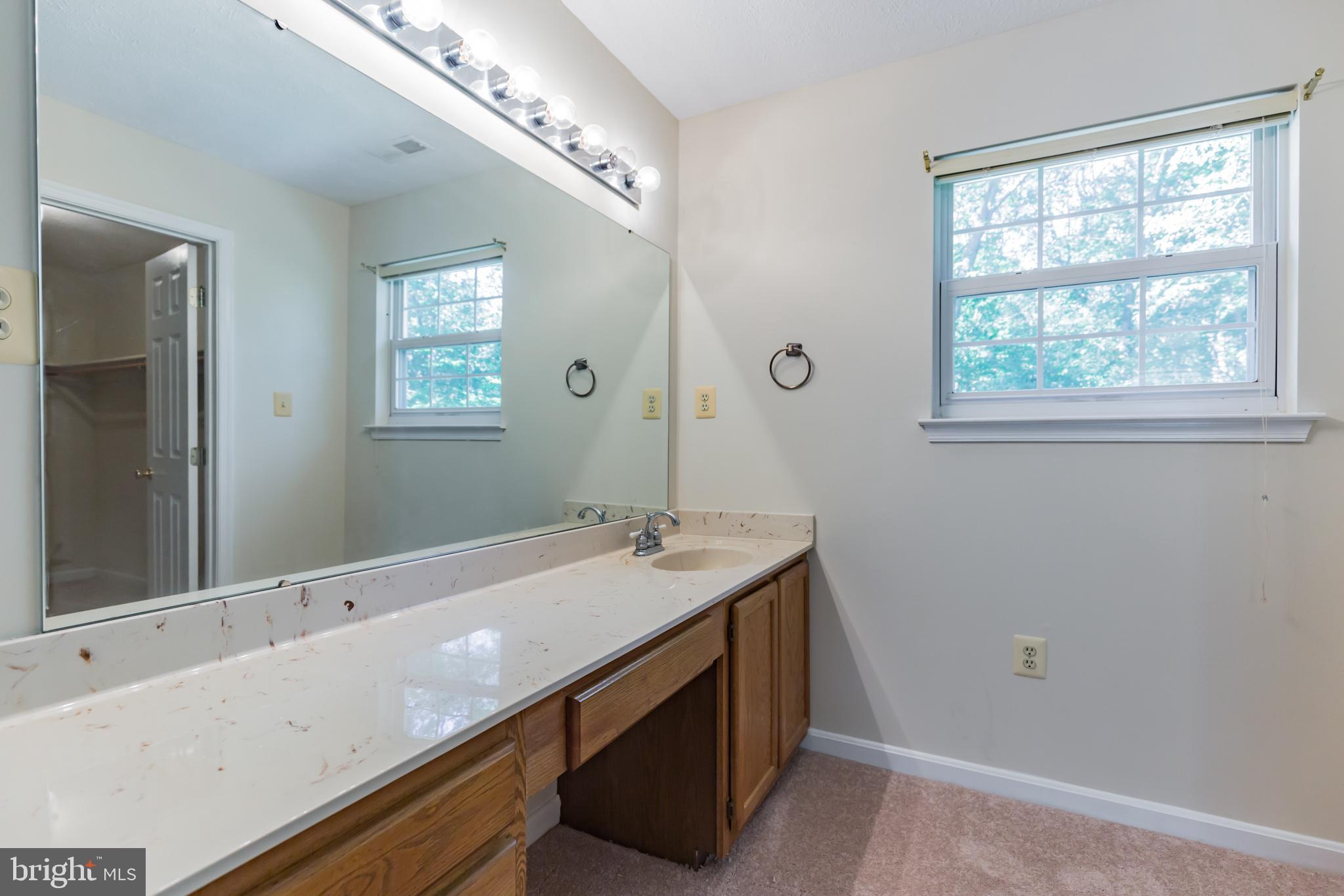 640 Small Reward Road Huntingtown, MD 20639 - Photo 11 of 28 a bathroom with a sink and a mirror