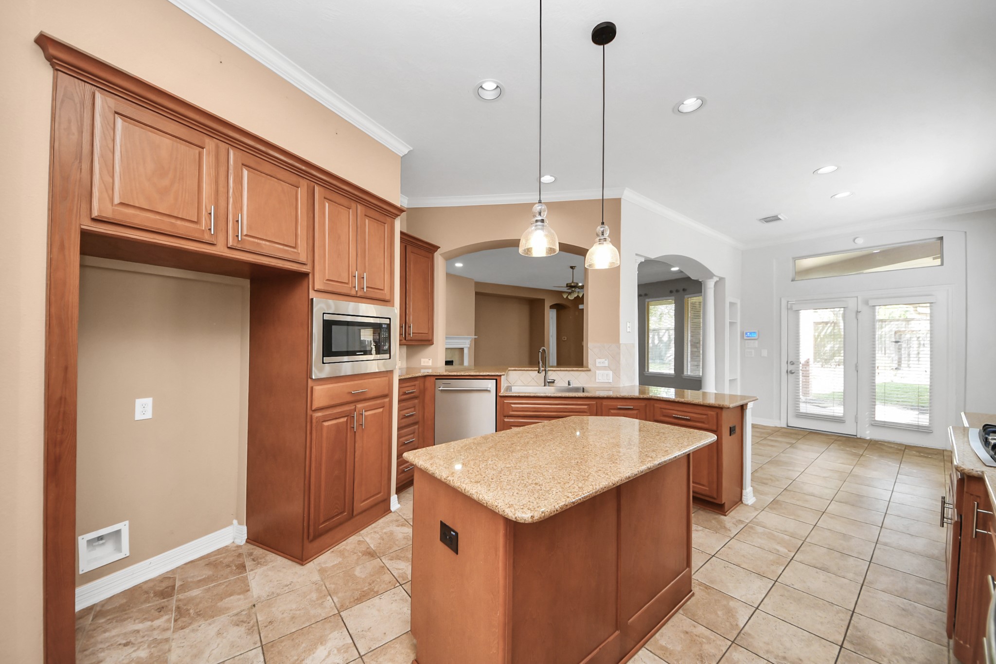 17618 Raven Canyon Lane Houston, TX 77095 - Photo 6 of 45 Spacious kitchen with rich wood cabinetry, granite countertops, and stainless steel appliances. Perfect for preparing meals and entertaining guests.