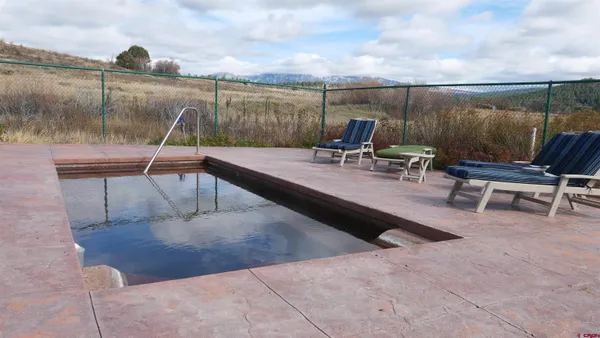 a view of a backyard with sitting area