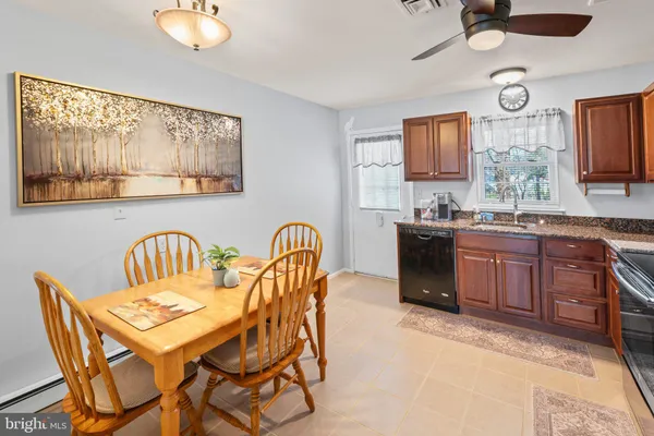 a view of a dining room with furniture and chandelier