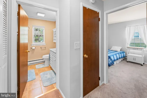a view of a room that has a bed and a view of bathroom