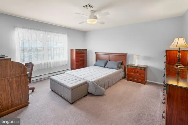 a bedroom with furniture and a large window